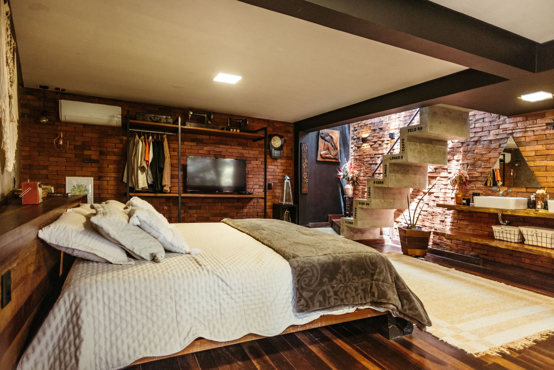 Stylish bedroom in Santa Teresa, Brasil with exposed brick and modern design.